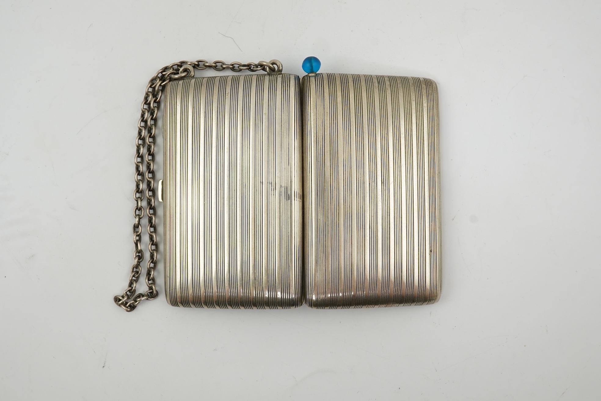 An early 20th century continental 800 standard silver combination, card, coin, aide memoir and pill case, with pencil and ribbed decoration, maker WK